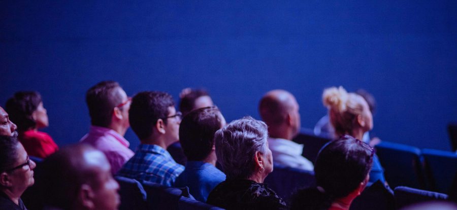 pexels-photo-2774556-2774556 An attentive group of adults seated at an indoor conference, focusing on a presentation.