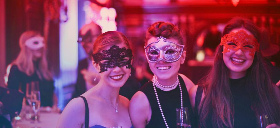 pexels-photo-787961-787961 A vibrant masquerade party with happy guests wearing decorative masks and holding champagne glasses.