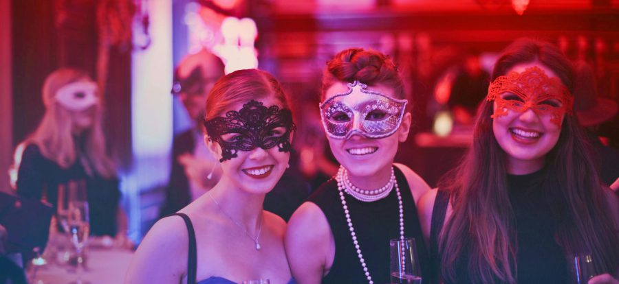 pexels-photo-787961-787961 A vibrant masquerade party with happy guests wearing decorative masks and holding champagne glasses.