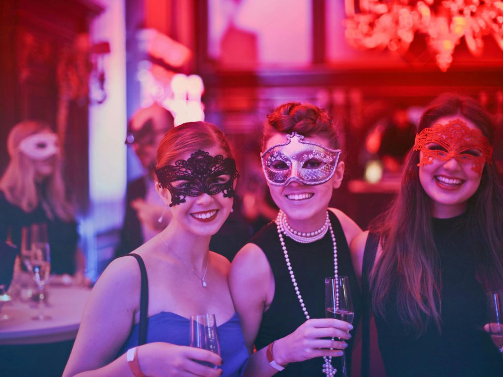 pexels-photo-787961-787961 A vibrant masquerade party with happy guests wearing decorative masks and holding champagne glasses.